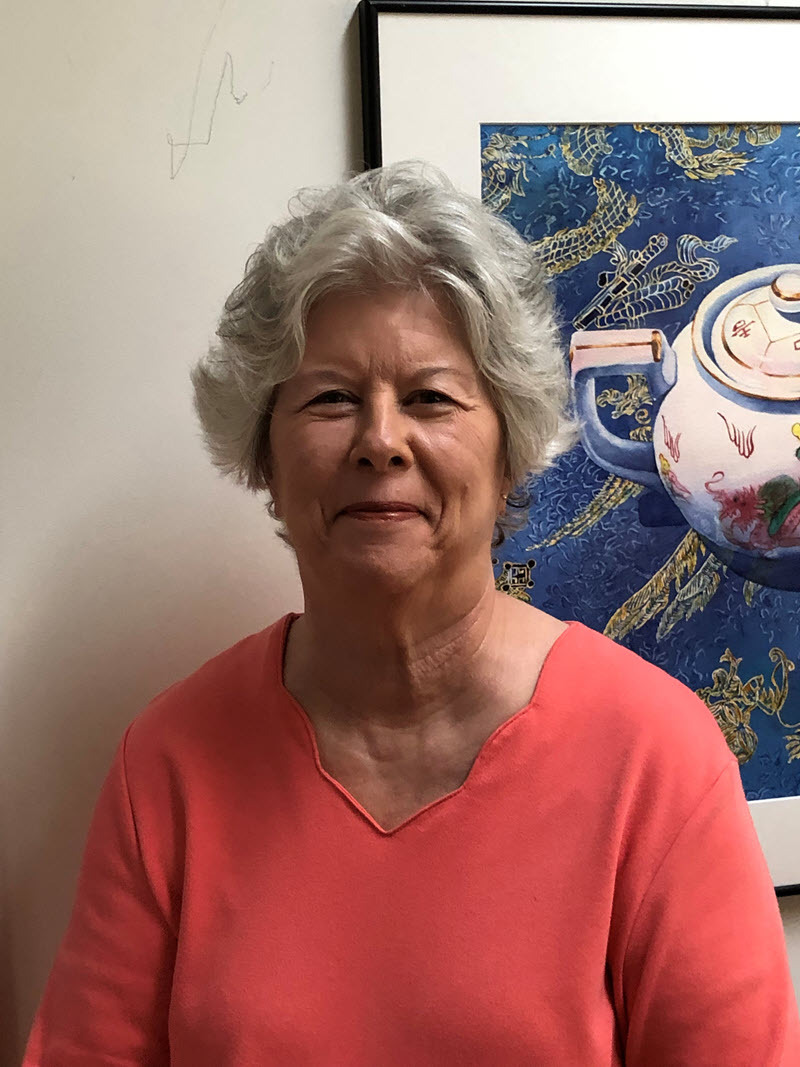 Deb Ward standing in front of her artwork
